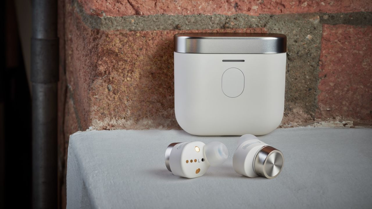 A Pair of Wireless Earbuds Sitting Next to a Charging Case on a Table — Complete Audio in Maroochydore, QLD