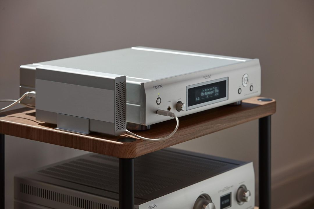 A Silver Amplifier is Sitting on Top of a Wooden Shelf — Complete Audio in Bribie Island, QLD