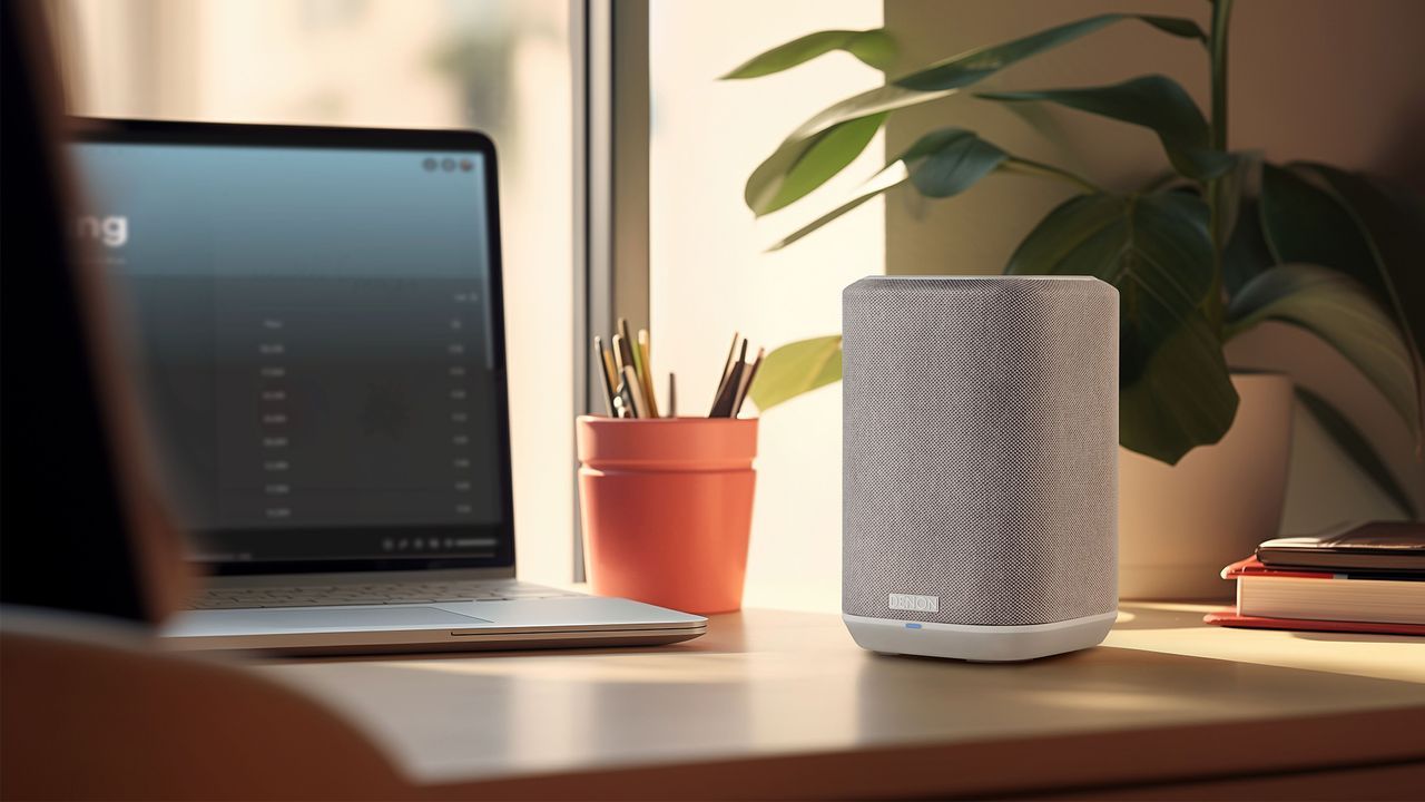 A Speaker is Sitting on a Desk Next to a Laptop and a Potted Plant — Complete Audio in Maroochydore, QLD
