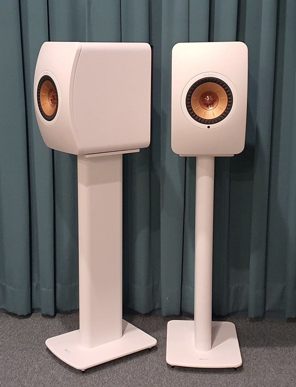 Two White Speakers Are Sitting on White Stands in Front of a Blue Curtain — Complete Audio in Maroochydore, QLD