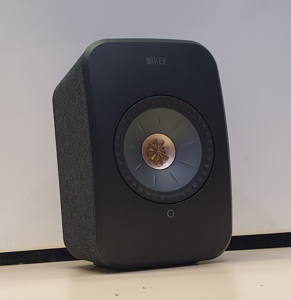 A Black Kef Speaker is Sitting on a White Surface — Complete Audio in Maroochydore, QLD