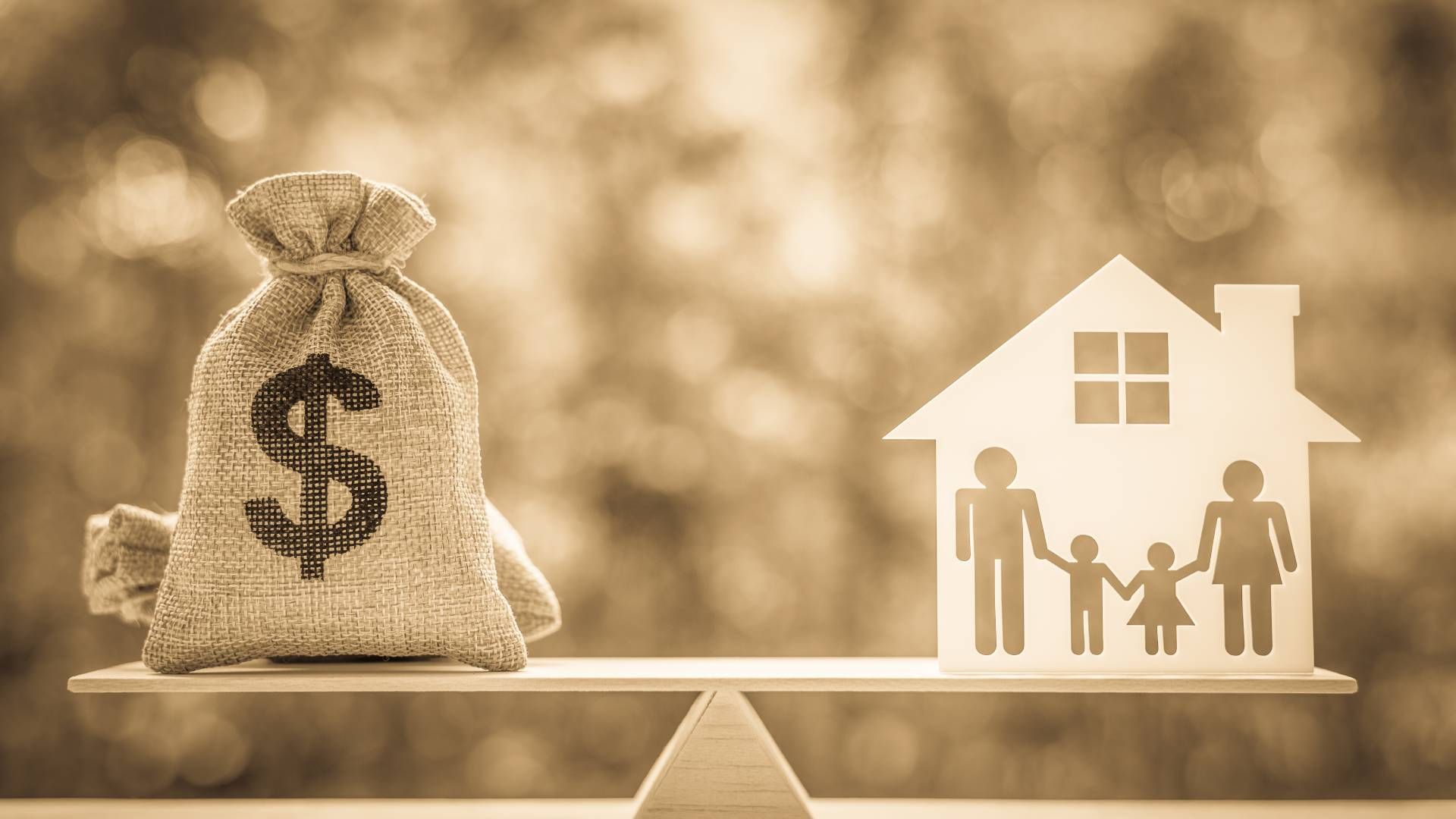 A scale with a bag of money , a house and a family on it.