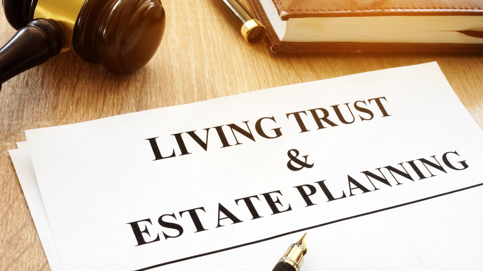 A living trust and estate planning document is sitting on a wooden table.