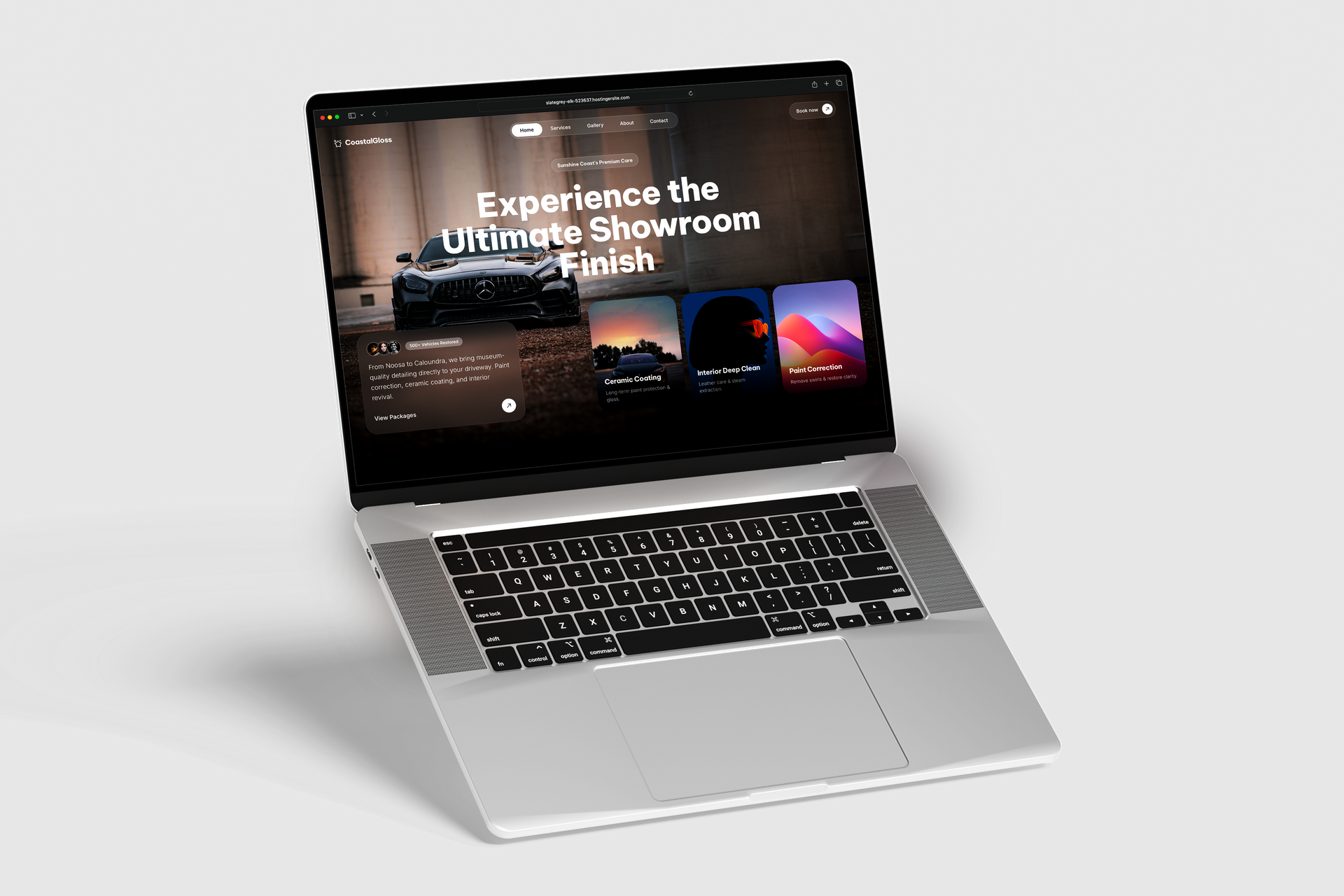 Silver laptop on a white background with a website open on its screen