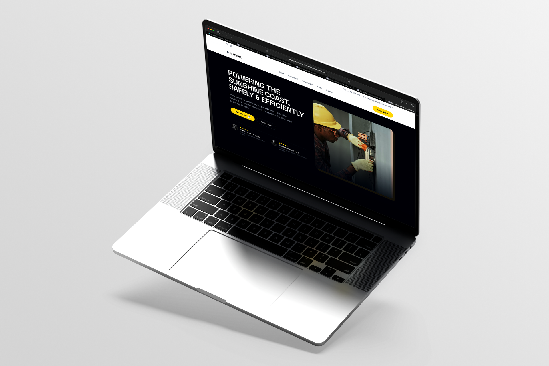 Open laptop displaying a dark website on a silver background