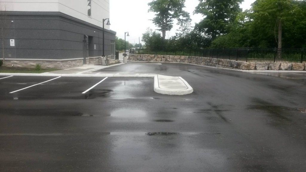 A parking lot in front of a building on a rainy day