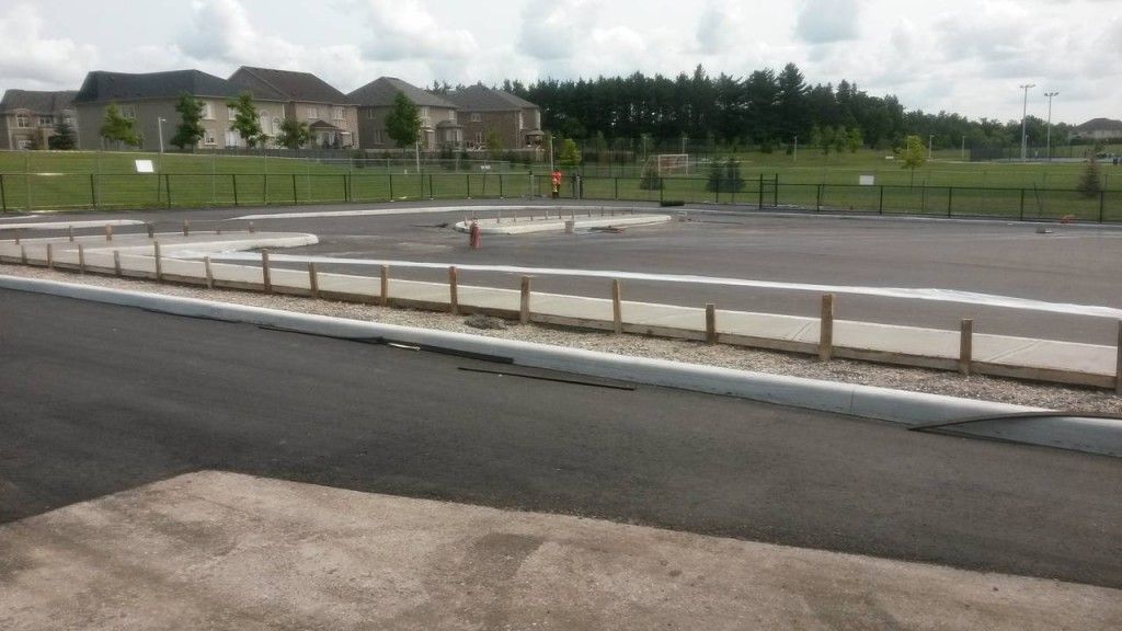 A fenced in area with houses in the background