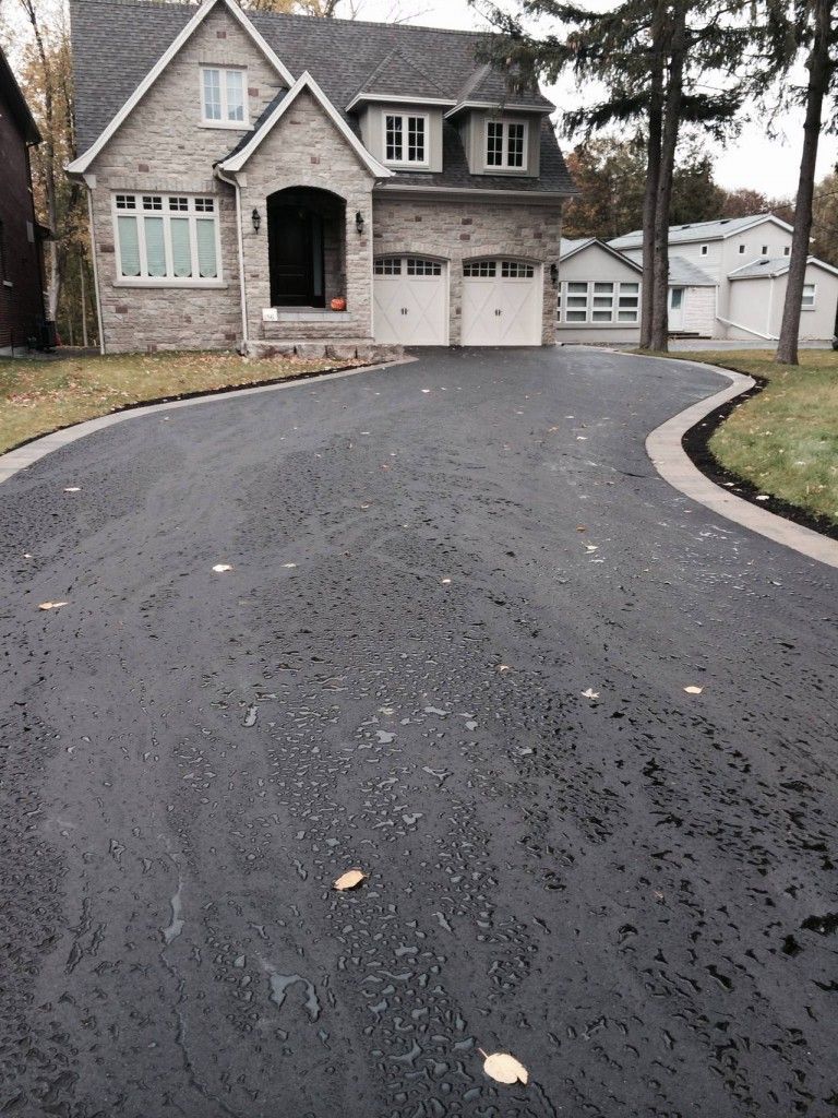 A house with a curved driveway leading to it