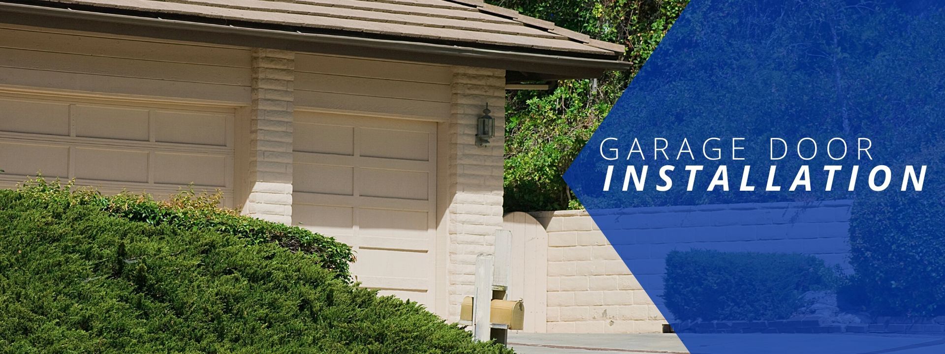 A white garage with matching doors next to a blue banner that reads
