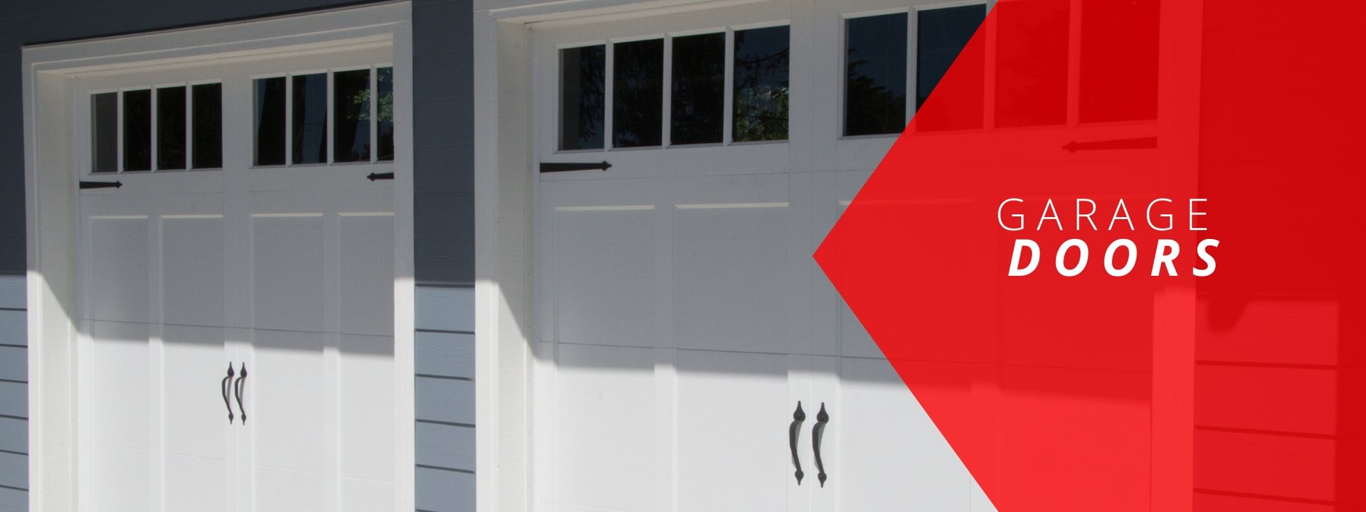 Two white carriage-style garage doors with windows and black hardware on a grey house, featuring a red text overlay.