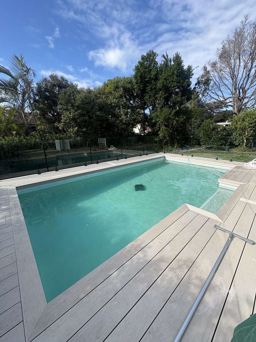A concrete swimming pool on the gold coast with decking around it