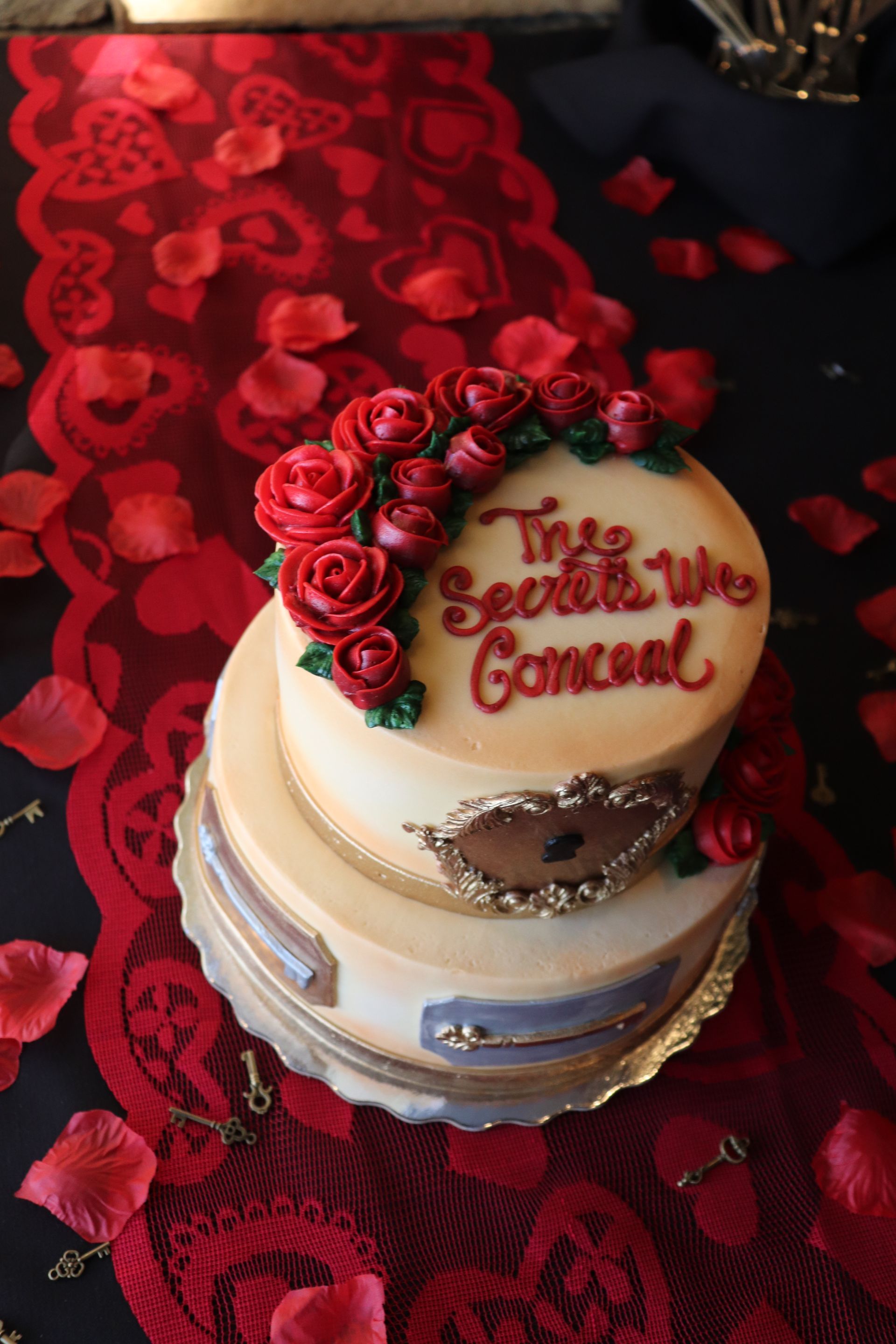 A cake with red roses and the words 
