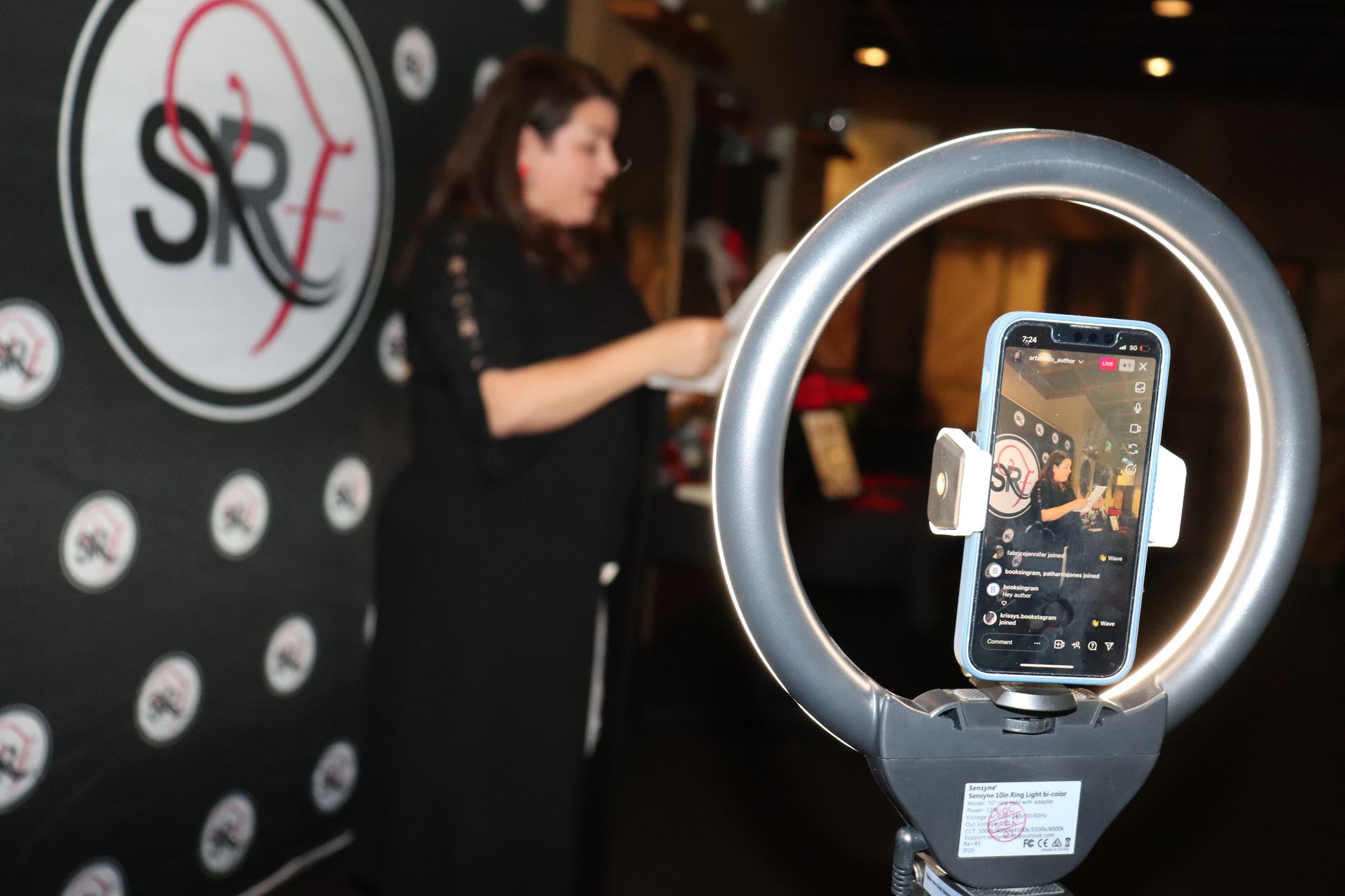 A woman is standing in front of a sign that says sr