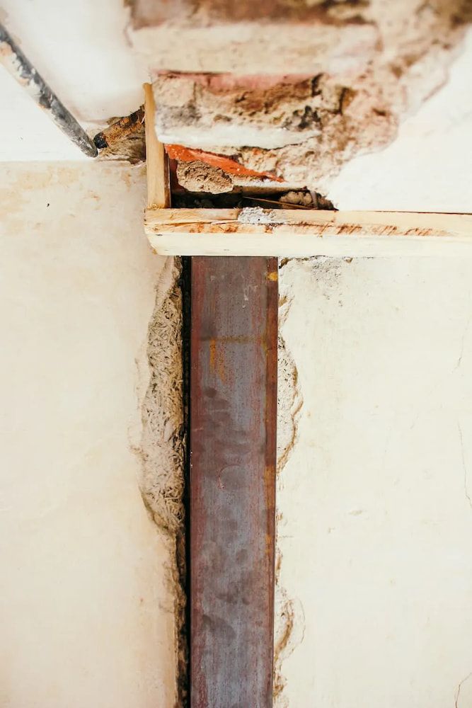 Rusty Metal Beam Supports Crumbling Ceiling, With Visible Brick — Unique Waterproofing Solutions in North Rocks, NSW