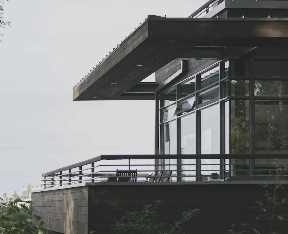 Modern Building With Large Windows, Dark Wood Trim, and a Balcony — Unique Waterproofing Solutions in North Rocks, NSW
