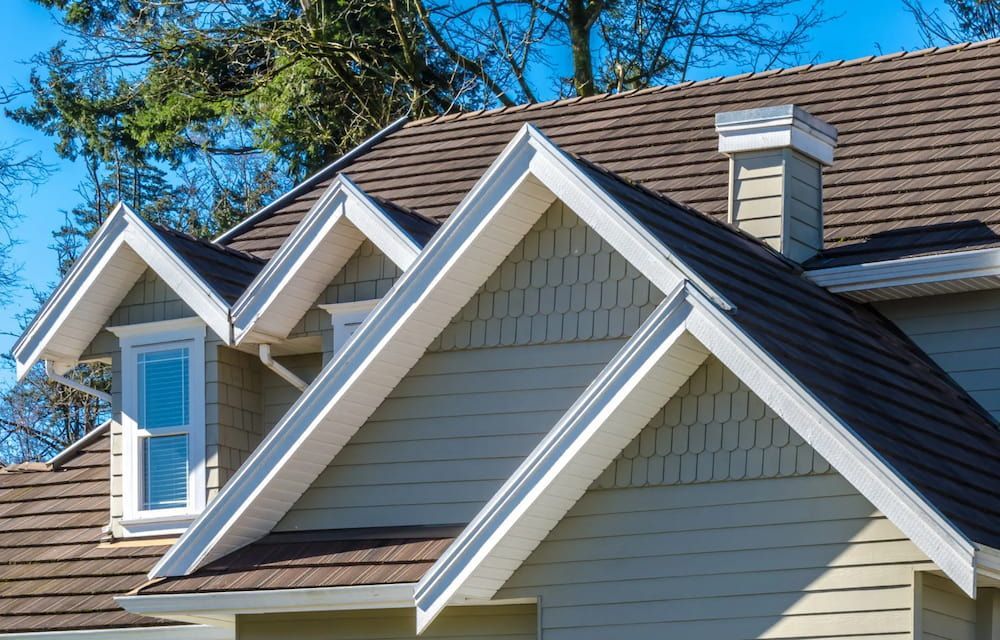 A House Roof With Three Dormers, Brown Shingles and White Trim — Unique Waterproofing Solutions in North Rocks, NSW