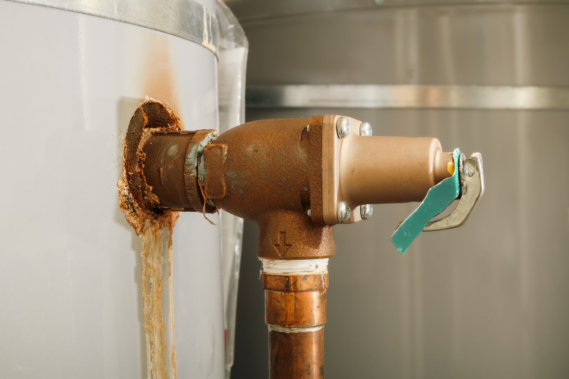 HVAC technician inspecting a corroded boiler and piping in an Endicott home, checking for leaks.