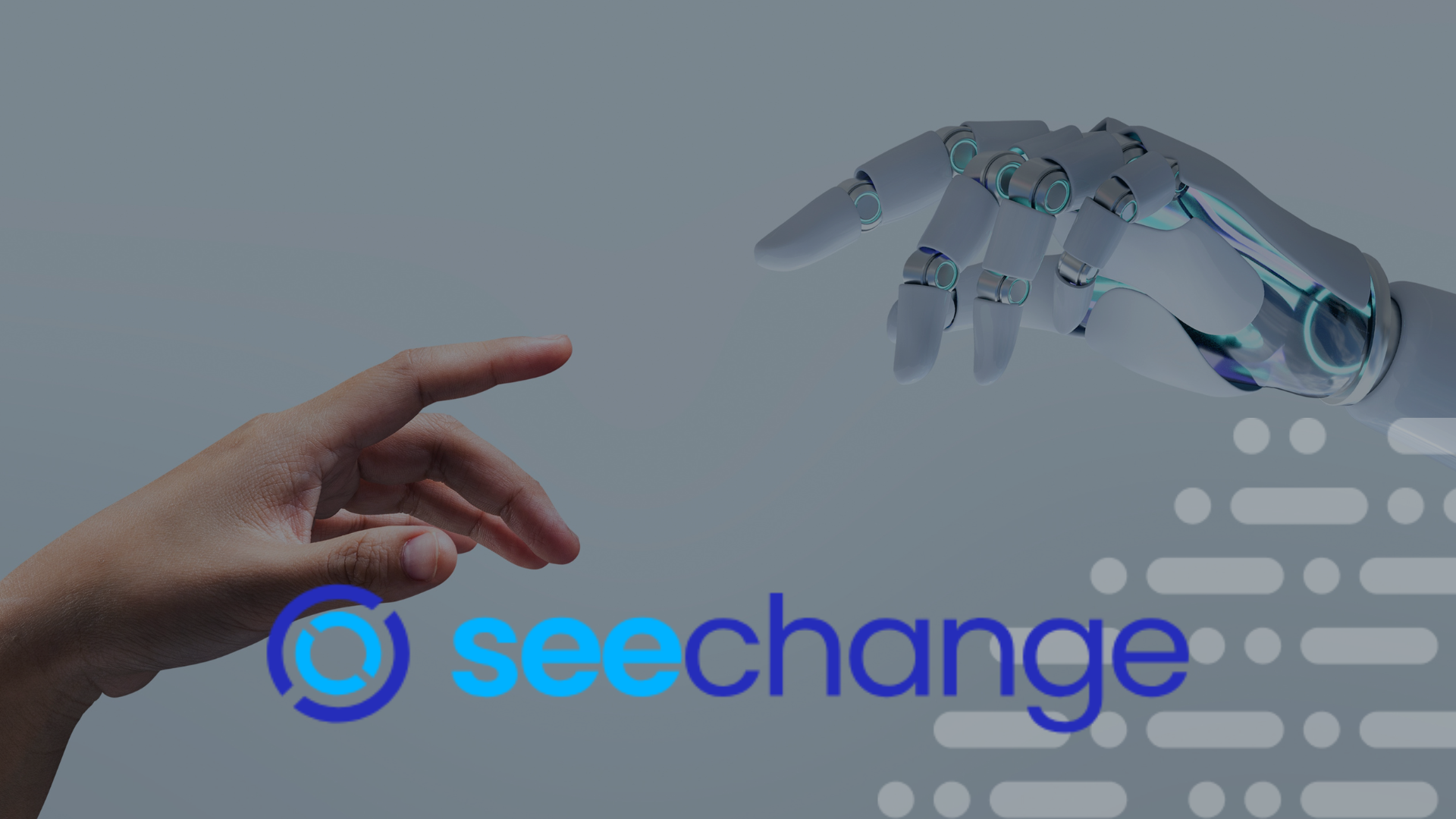 A human hand reaches toward a robotic hand against a gray background with the blue 