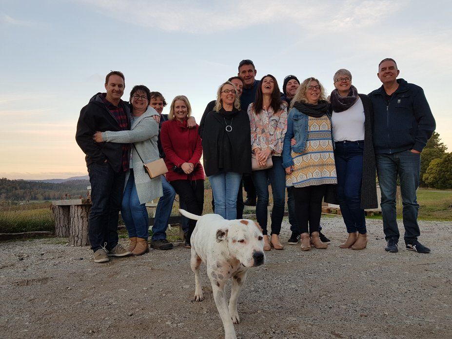group of man and woman with dog walking infront