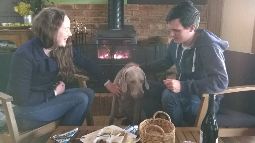 Husband and wife with their dog on a wine tour.