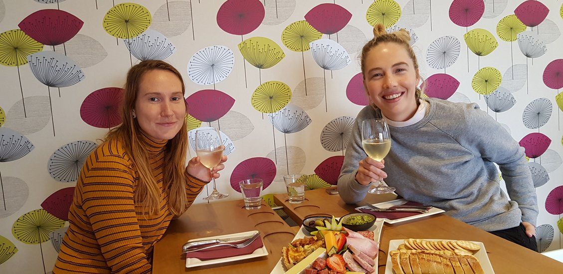 two woman drinking wines