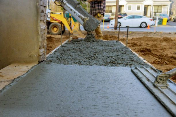 worker pouring wet cement in the floor