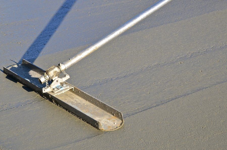 worker flattens the wet cement