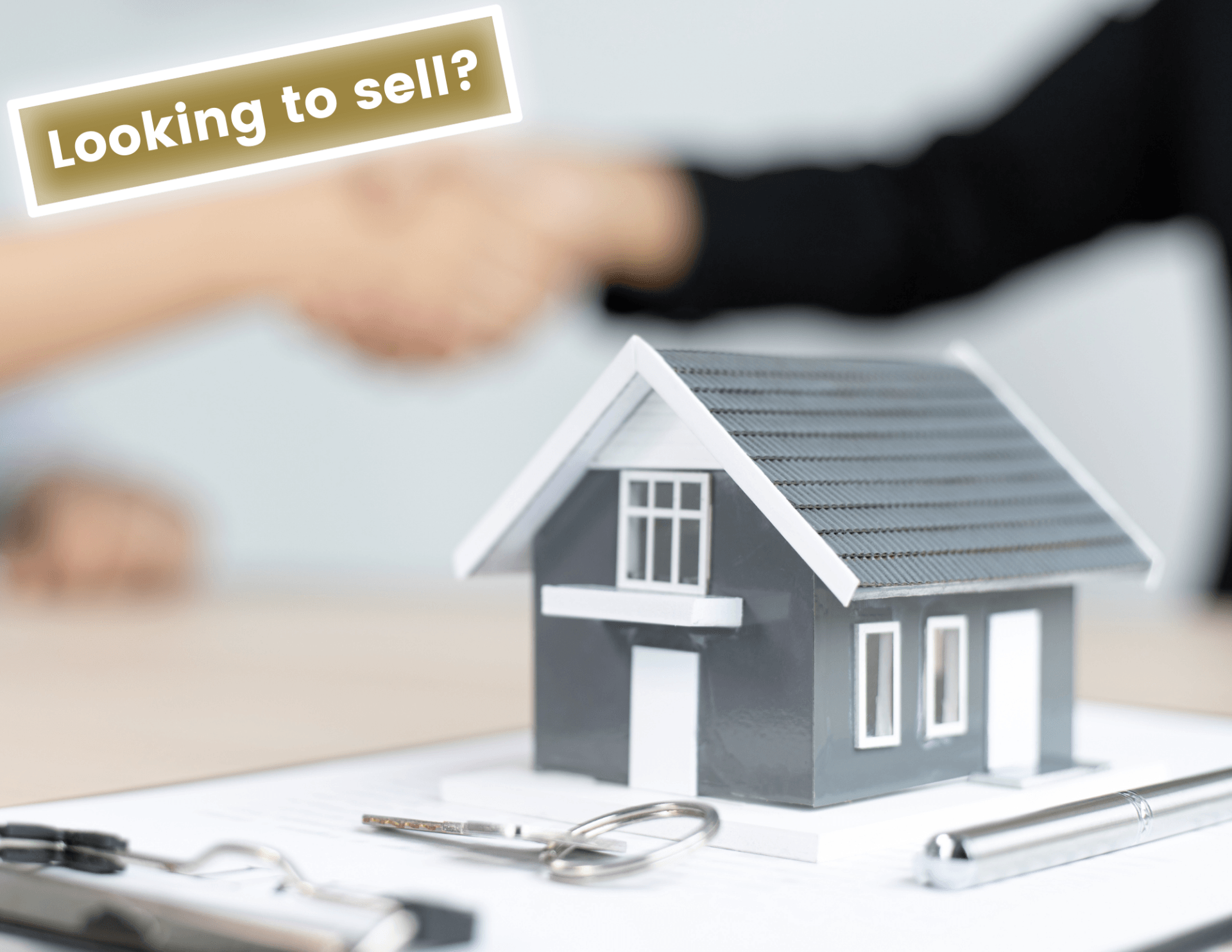 small scale home with a handshake in the background closing a deal. Hurley Ent. will buy your house if it is for sale!