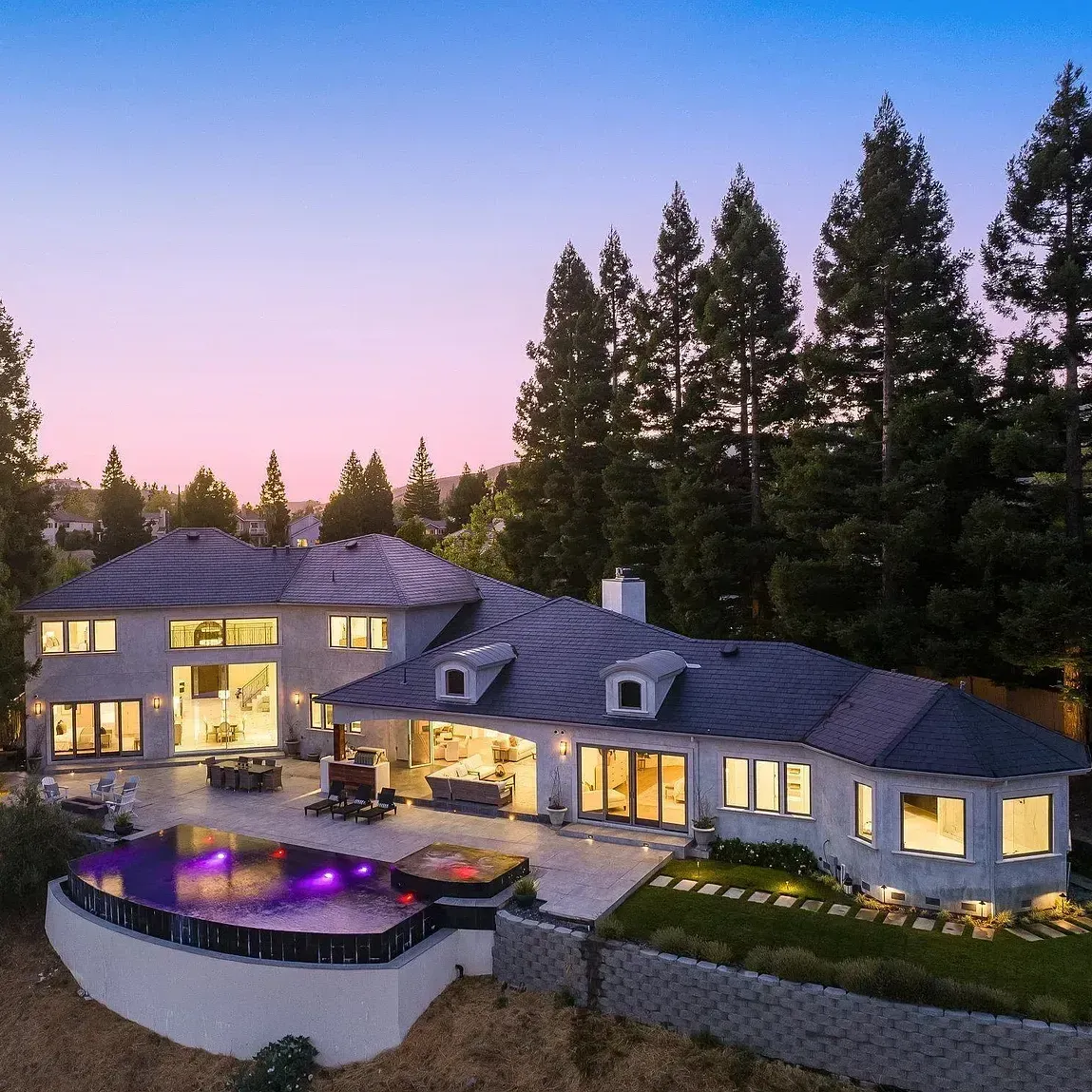 An aerial view of a large house with a pool in the backyard