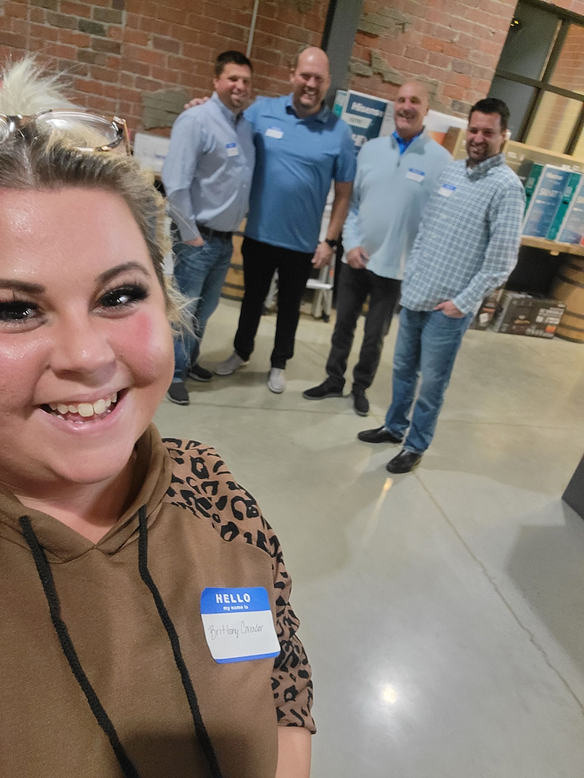 Brittany taking a photo with the guys at christmas party