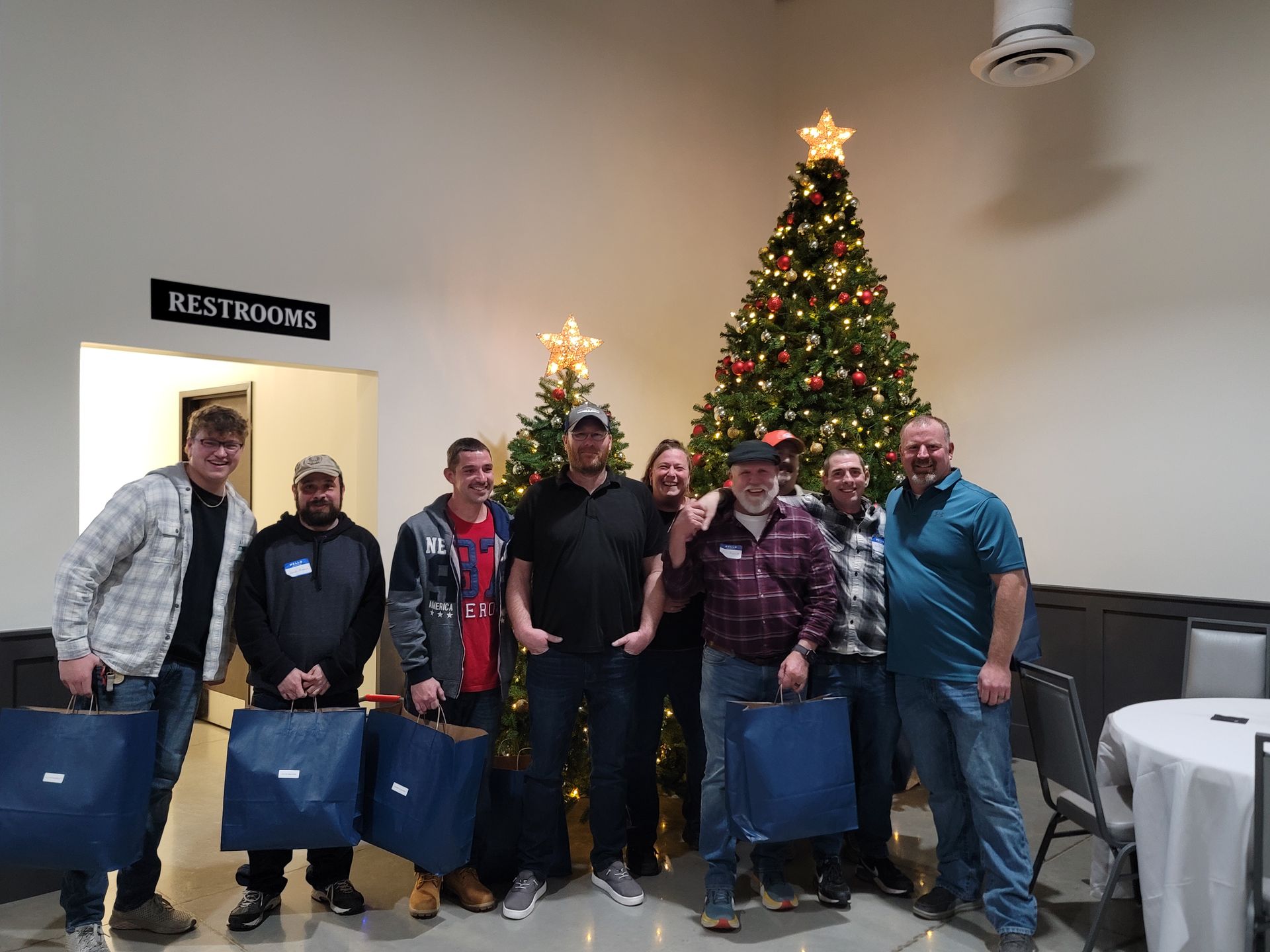 Employees in front of christmas tree