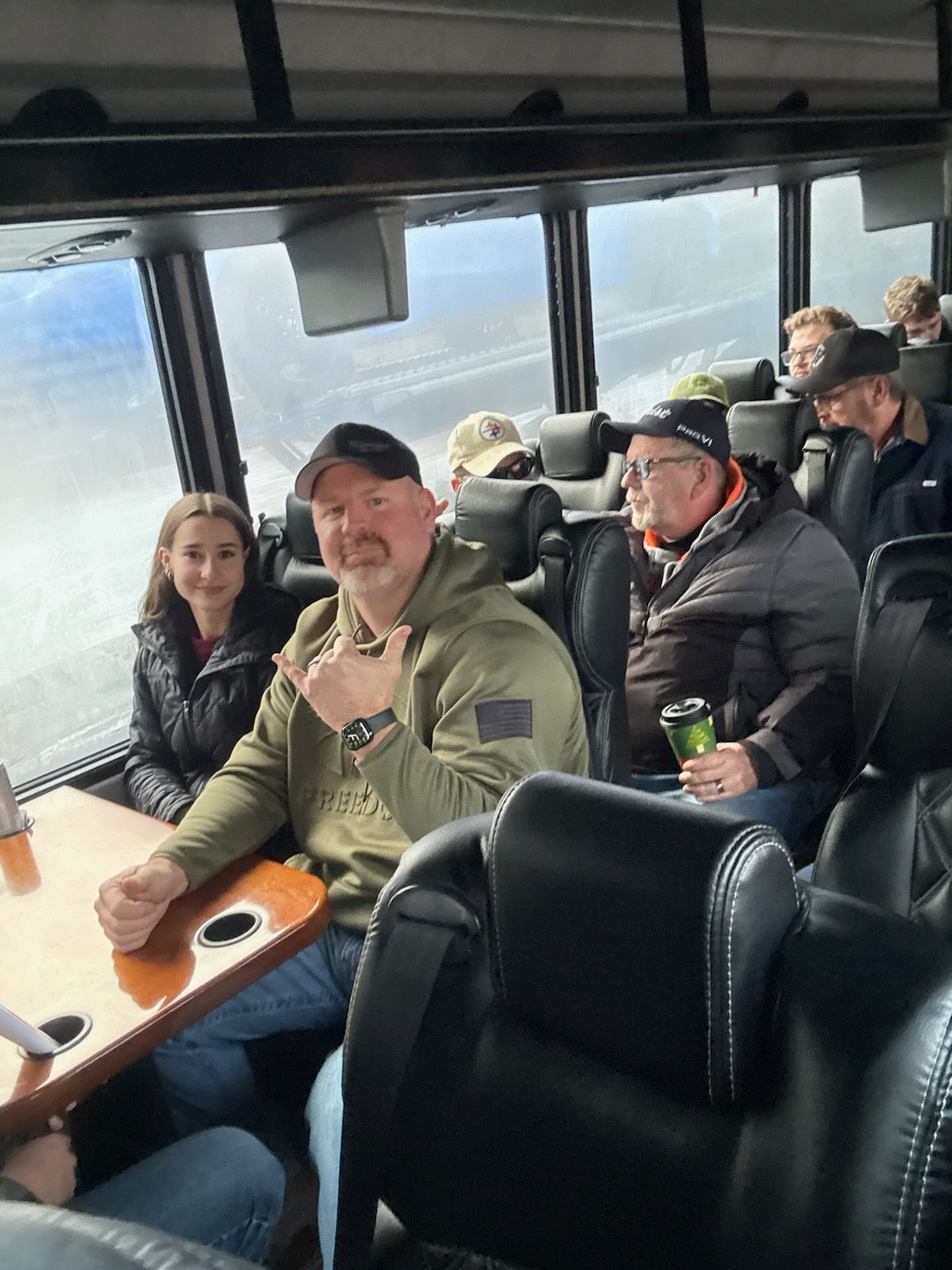 Employees riding bus to golf outting