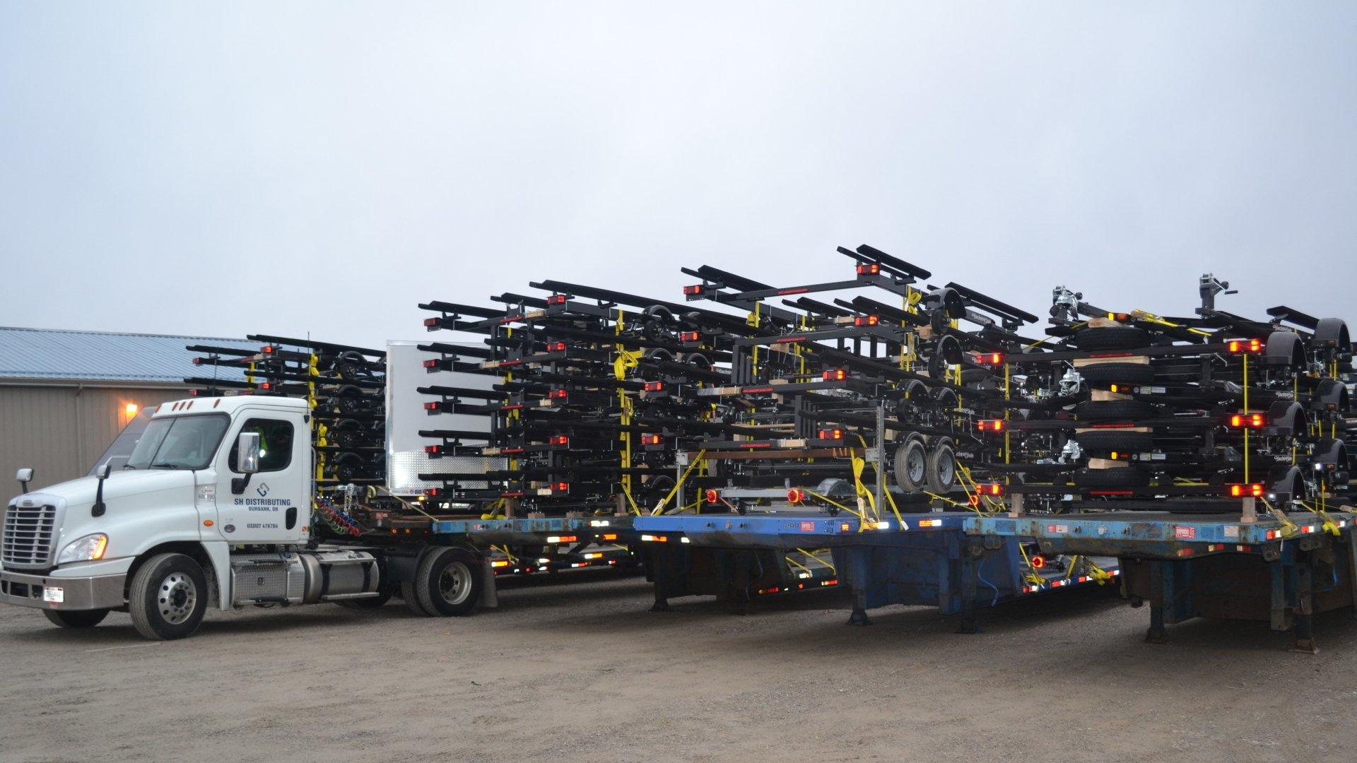 truck hauling load of trailers