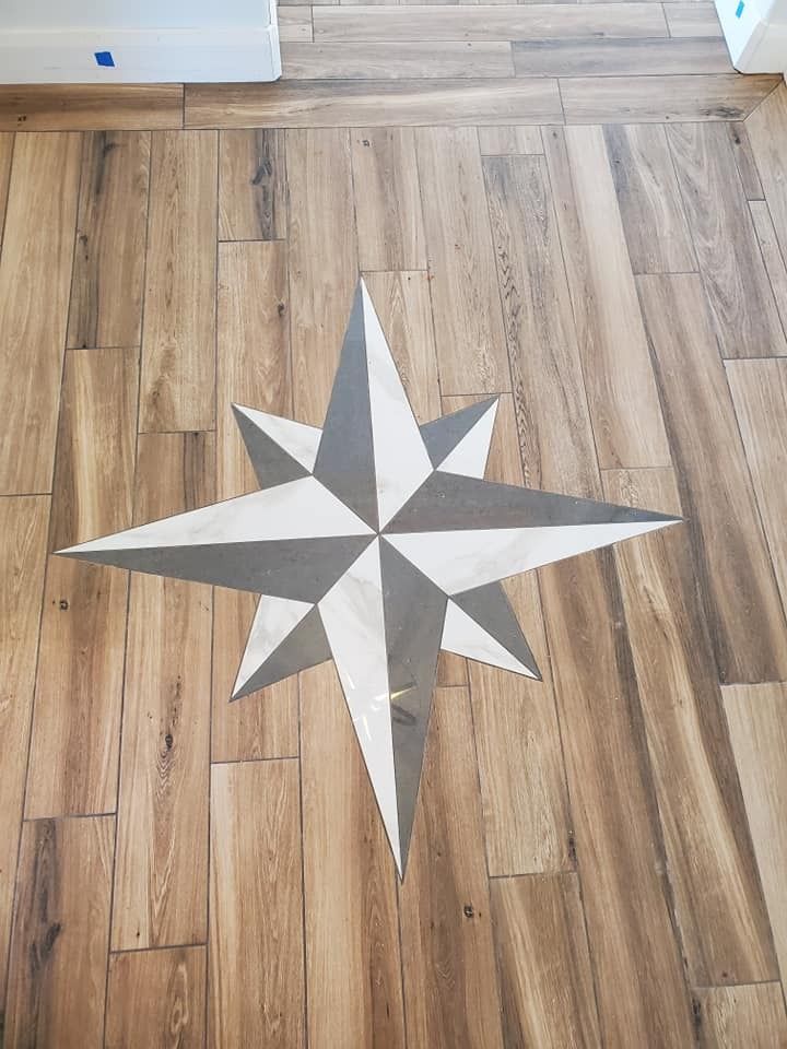 A black and white photo of a shower with a stone wall.