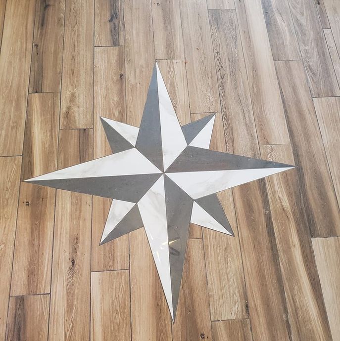 A wooden floor with a star in the middle