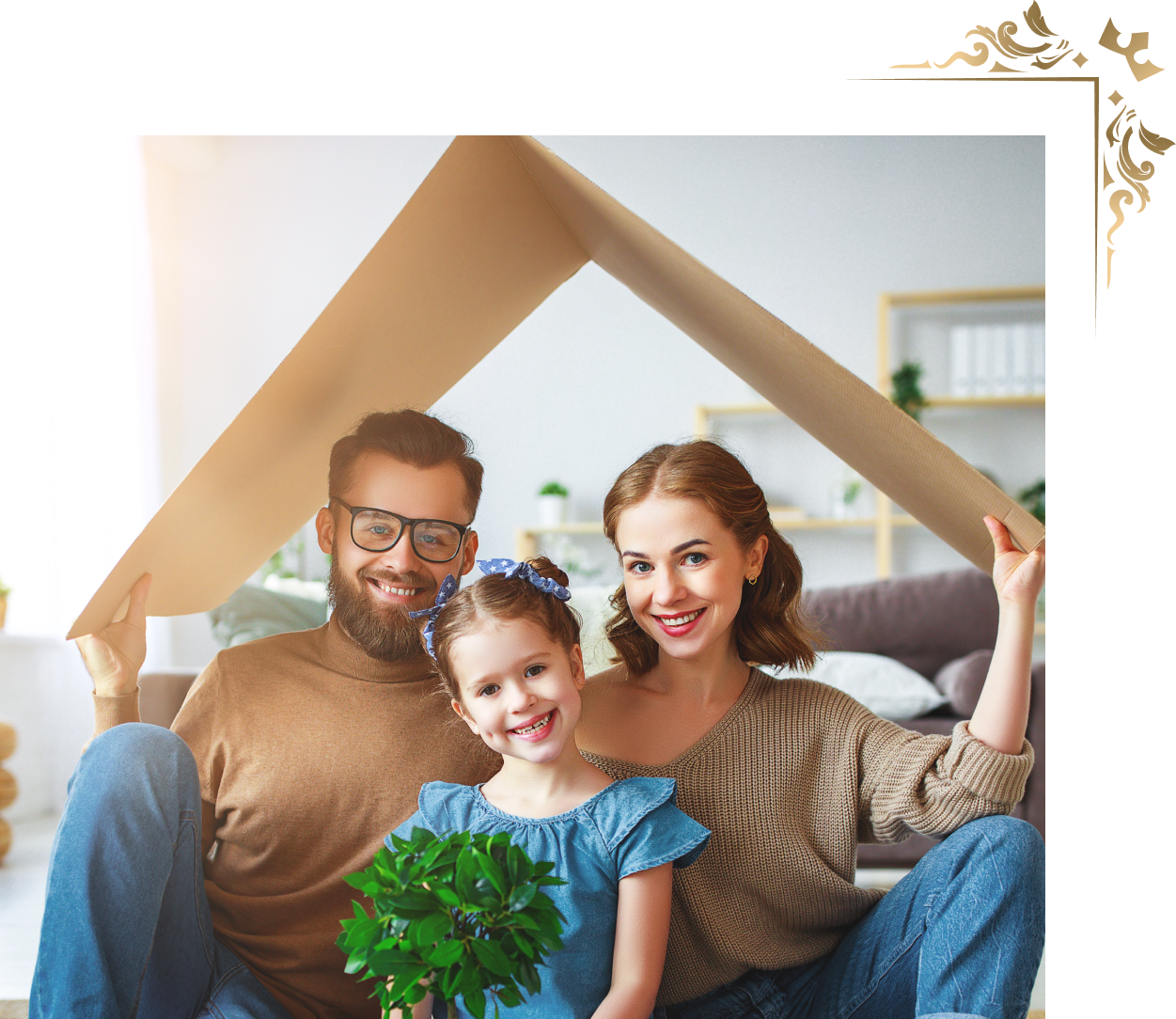 A family is sitting under a cardboard house.