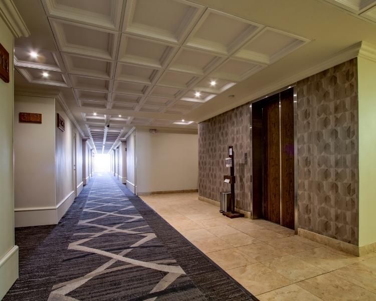 A long hallway with an elevator in the corner