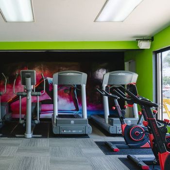 A gym with treadmills and exercise bikes