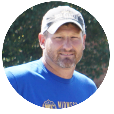 A man wearing a blue shirt with the word midwest on it