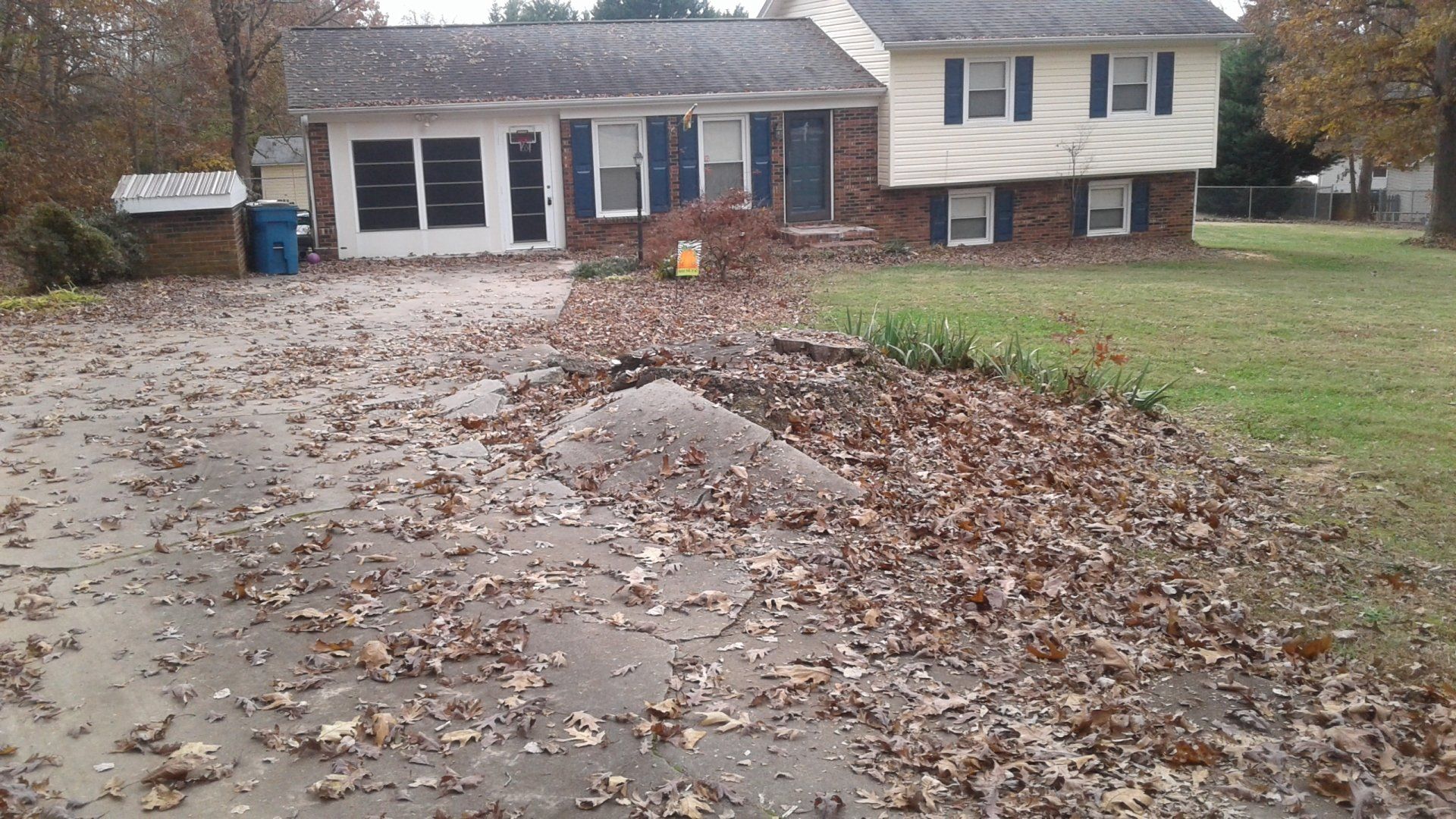Large stump tearing up a driveway
