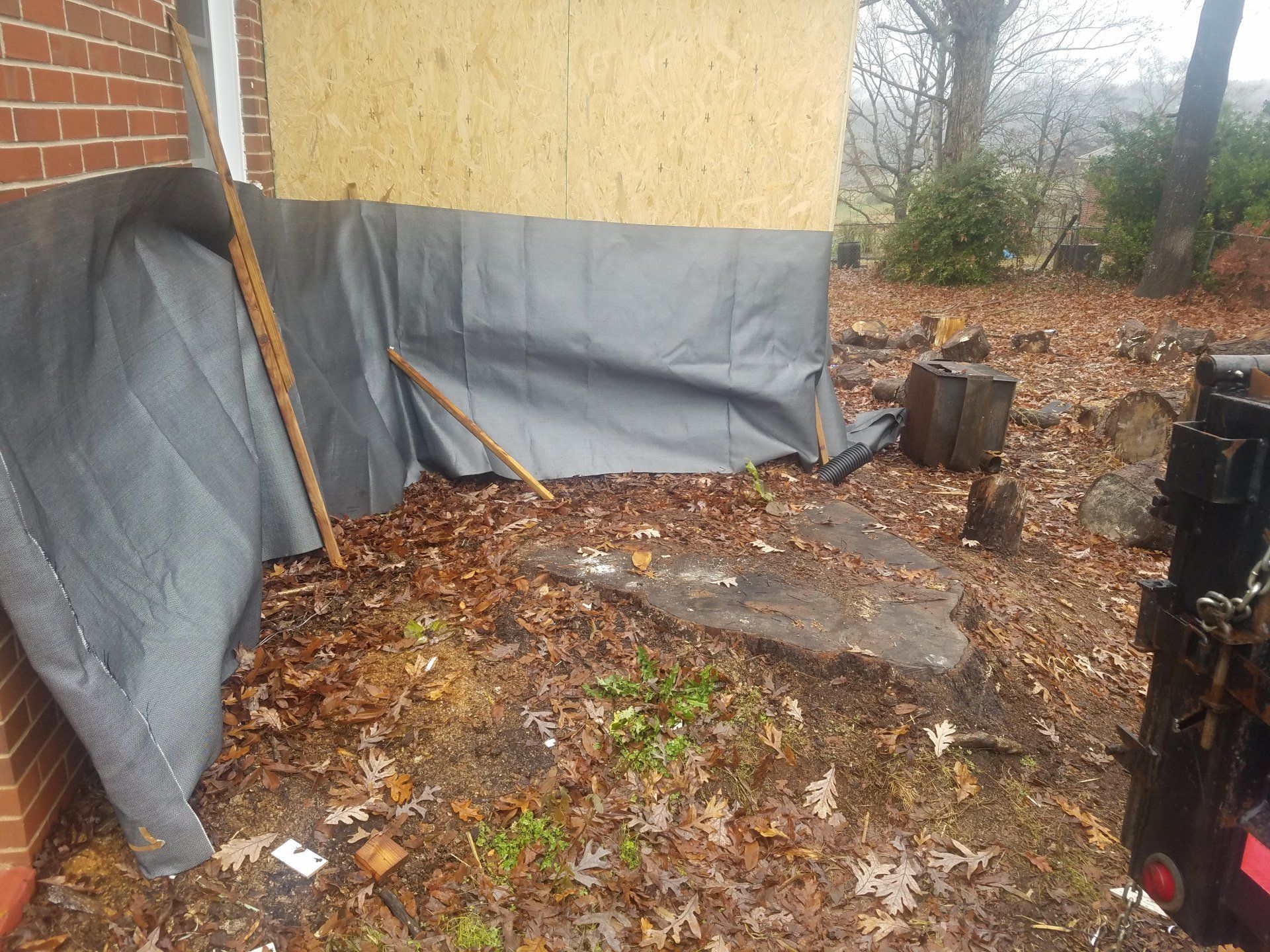 large stump next to a house