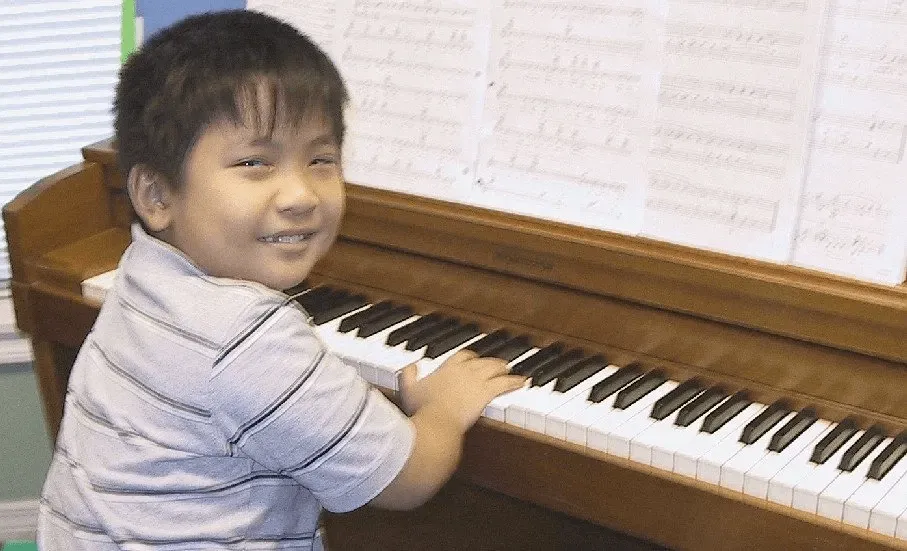 little boy playing piano