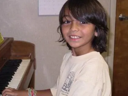 a boy playing piano