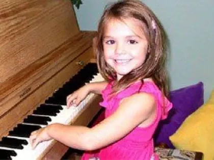 little girl playing piano