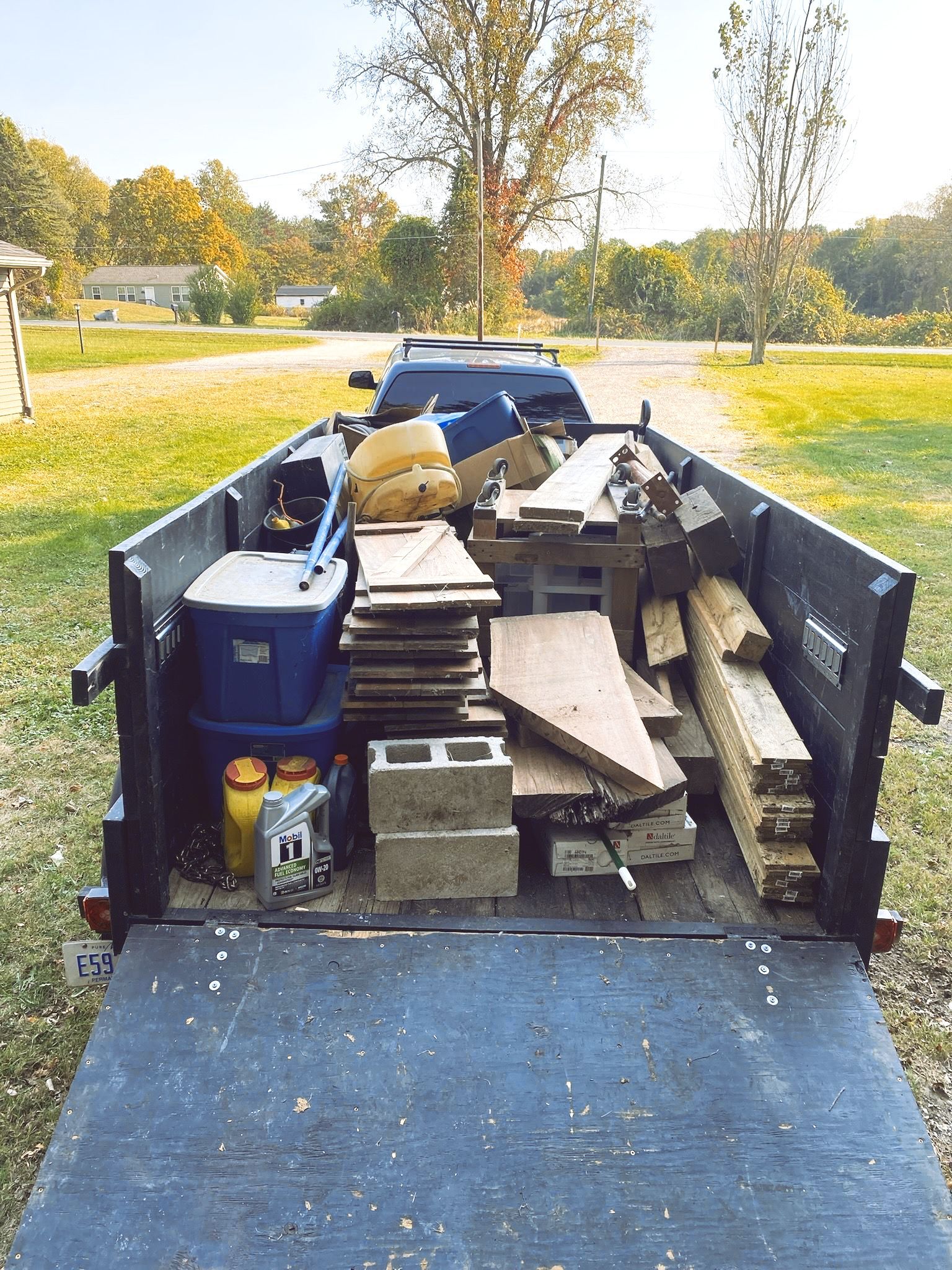 The back of a dumpster filled with wood and bricks