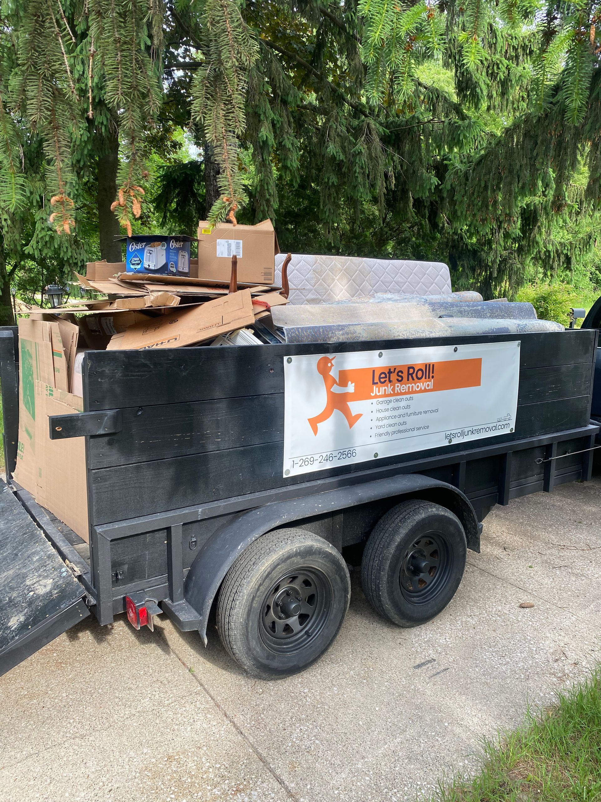 A dumpster with a sign that says let 's roll on it