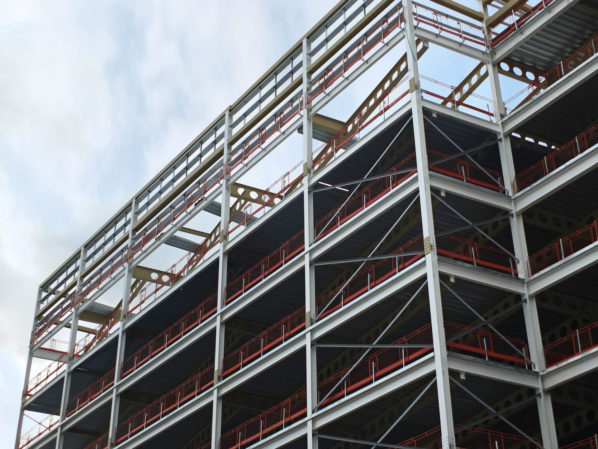 Partially built steel-framed construction site against a cloudy sky Partially built steel-framed construction site against a cloudy sky