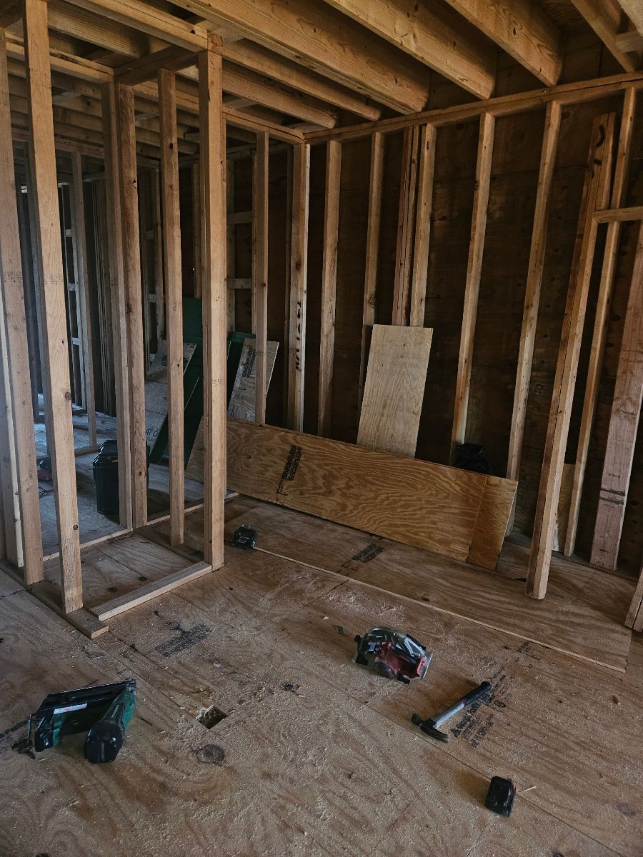 Wood stud framing for interior walls during early stage of residential remodel