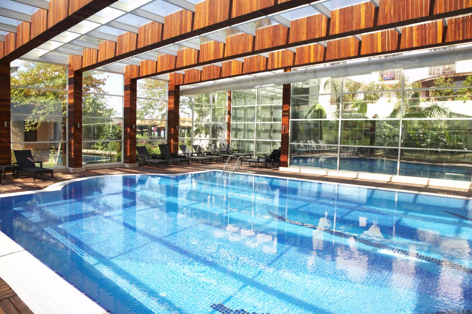 covered swimming pool with glass barriers