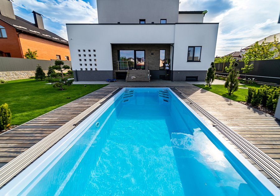 long swimming pool with wood pool deck